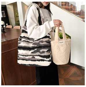 Detailed view of plush lamb wool tote bags in speckled grey and cream white colors