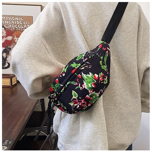 Close-up of floral nylon crossbody bag with green leaf and red flower pattern