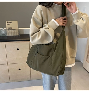 Army green nylon crossbody bag with large capacity and outer pocket detail