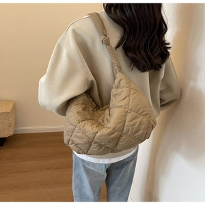 Detailed back view of a khaki quilted puffer tote bag with a stylish knotted shoulder strap