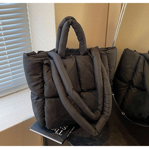Chic black quilted puffer tote bag with dual straps for autumn and winter fashion