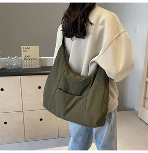 Olive green large capacity nylon hobo shoulder bag with wide strap on model