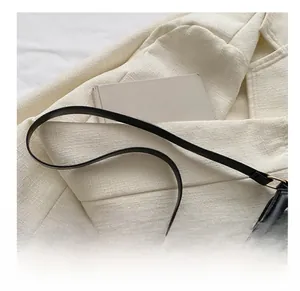 Close-up of black PU leather underarm bag featuring elegant V-quilted texture and gold buckle