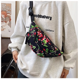 Detail of trendy nylon crossbody bag featuring floral pattern and durable plastic buckle