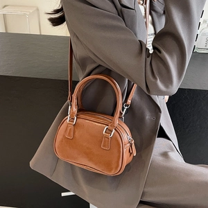 Brown glossy PU leather mini Boston bag with silver hardware and shoulder strap details