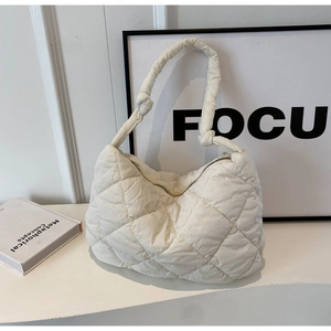 Minimalist cream white quilted shoulder bag with puffy diamond stitch and knotted strap