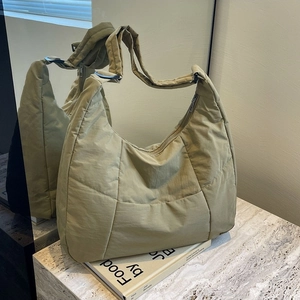 Minimalist large olive green quilted crossbody bag with stylish wide shoulder strap