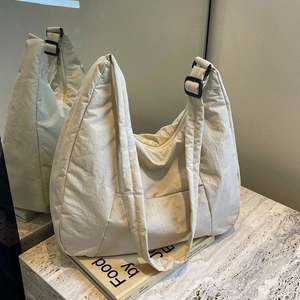Minimalist cream puffer hobo bag with adjustable strap and large capacity fabric design
