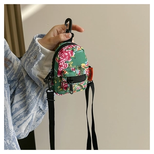 Mini floral backpack pendant with peony pattern, clip attachment and black zipper detail