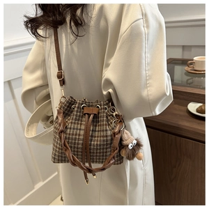 Brown plaid drawstring bucket bag with leather woven handle and cute plush charm pendant