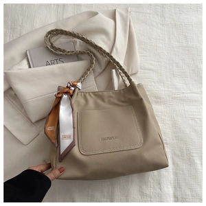 Khaki pebbled leather tote bag with braided straps and decorative silk scarf detail