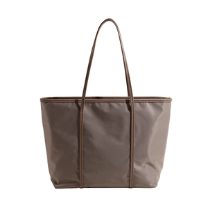 Minimalist nylon tote bag in dark brown with elegant leather straps and smooth finish