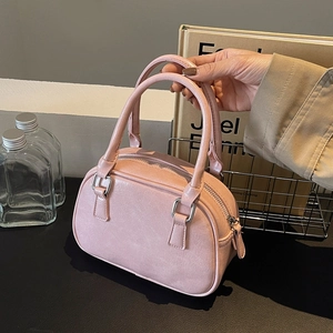 Detail of soft pink PU leather mini Boston bag with silver zipper and dual handles