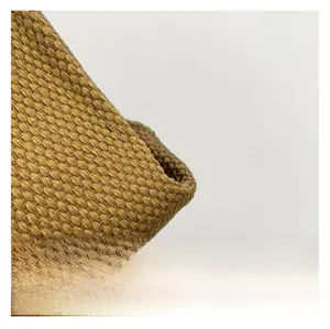 Close-up detail of khaki woven fabric texture on a stylish women's shoulder handbag
