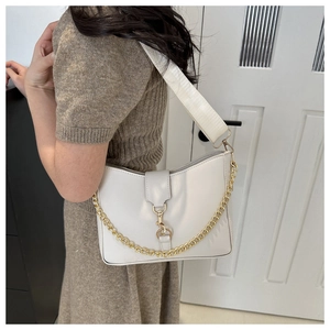 Detailed side view of a white crescent hobo bag with fabric strap and gold chain link detail