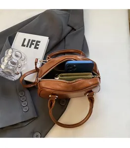 Top view of spacious interior in a brown Boston handbag showing storage capacity