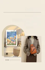 Detail of caramel brown PU shoulder bag featuring geometric pattern wide strap and dual zippers