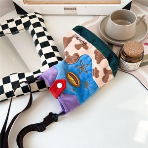 Detail of the cowboy boot shaped crossbody bag with star embroidery and soft velvet texture