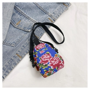 Blue canvas crossbody bag featuring pink floral peony print and adjustable black strap