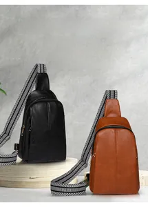 Detail of trendy textured chest bags in black and brown with striped woven straps