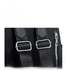 Detail of adjustable silver buckle on black lychee texture PU leather backpack strap