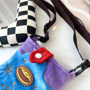 Detail of color-block plush crossbody bag with star embroidery and brand logo patch
