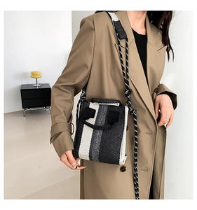 Detailed view of the striped woven fabric texture on a modern crossbody tote bag