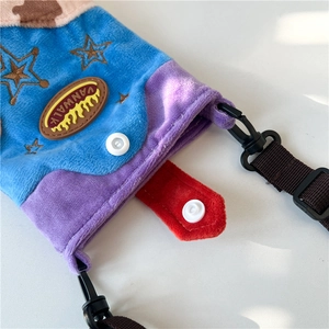 Detail of the colorful plush wool crossbody bag with a star embroidery and snap closure
