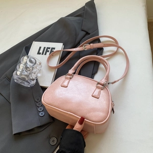 Chic pink PU leather bowling bag with top handles and adjustable silver strap