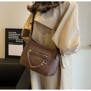 Detailed close-up of dark brown litchi pattern PU leather Hobo bag with gold chain
