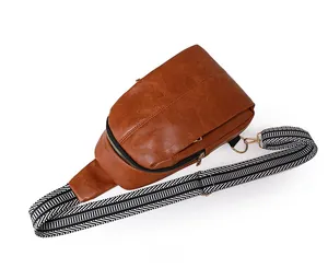 Detailed top view of retro brown pebble leather crossbody bag with striped strap and zipper