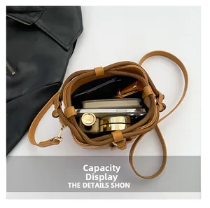 Spacious interior of tan PU leather bucket bag showing phone and cosmetics storage