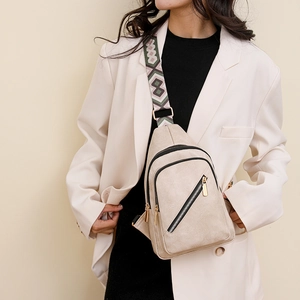 Detail of beige PU leather chest bag with a vintage colorful geometric woven strap