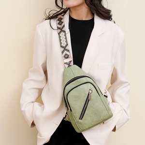 Detail of light green PU leather crossbody bag with ethnic style geometric guitar strap