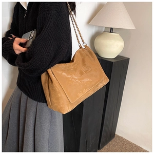Détail du sac à bandoulière en cuir PU kaki avec surpiqûres et bandoulière chaîne dorée