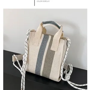 Chic woven tote bag with blue and olive green stripes and rope handles for winter