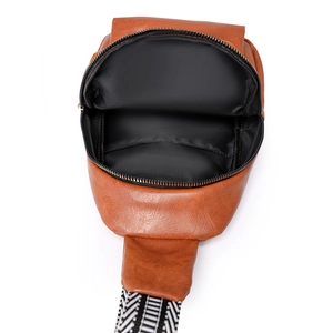 Detailed interior view of a brown retro crossbody bag with textured fabric and wide strap