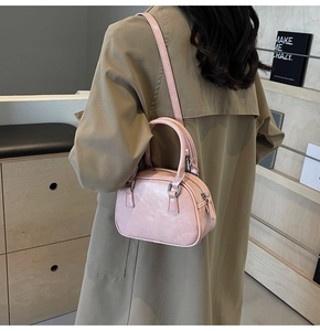 Rear view of model wearing pink PU leather crossbody bag showing size and styling detail