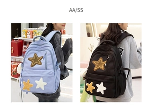 Detail view of stylish canvas backpack with star patches in purple and black colors