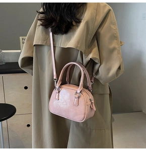 Detailed back view of a pink mini crossbody bag styled with a professional trench coat