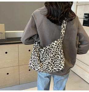 Vue arrière d'un mannequin portant un grand sac bandoulière en toile à motif léopard