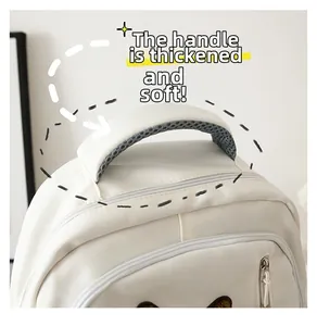Detail of white backpack featuring a thick sponge-filled handle for comfortable carrying