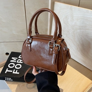 Chic brown PU leather Boston bag with double handles and adjustable crossbody strap
