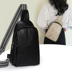 Fashionable faux leather crossbody bag with geometric woven strap in black and beige tones