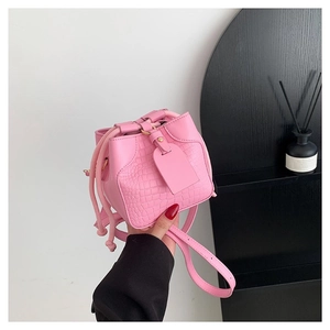 Pink crocodile-embossed mini bucket bag with drawstring closure and slim shoulder strap