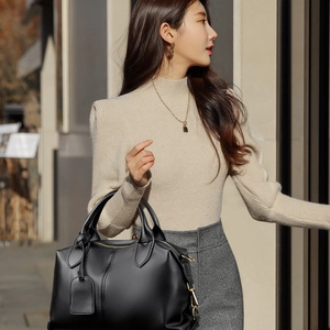 Minimalist black leather Boston handbag for women with dual handles and crossbody strap