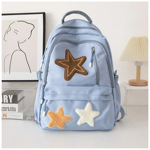Stylish light blue canvas backpack with colorful plush star patches and top handle