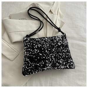 Chic black and silver sequined shoulder bag with minimalist rope straps for winter