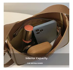 Internal view of the brown PU leather crescent shoulder bag showing storage capacity