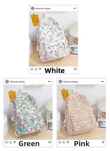 Gros plan détaillé des sacs à dos en tissu Oxford fleuri en blanc, vert et rose